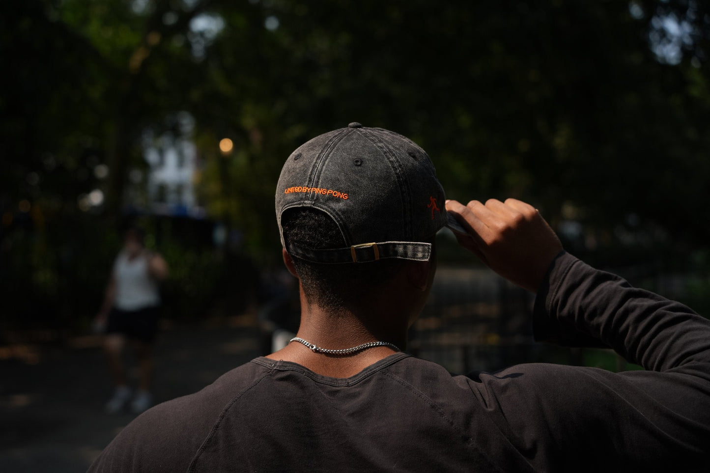 SPIN Club Cap black, UNITED BY PING PONG back arch, worn