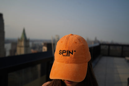 SPIN Club Cap orange, worn, NYC skyline