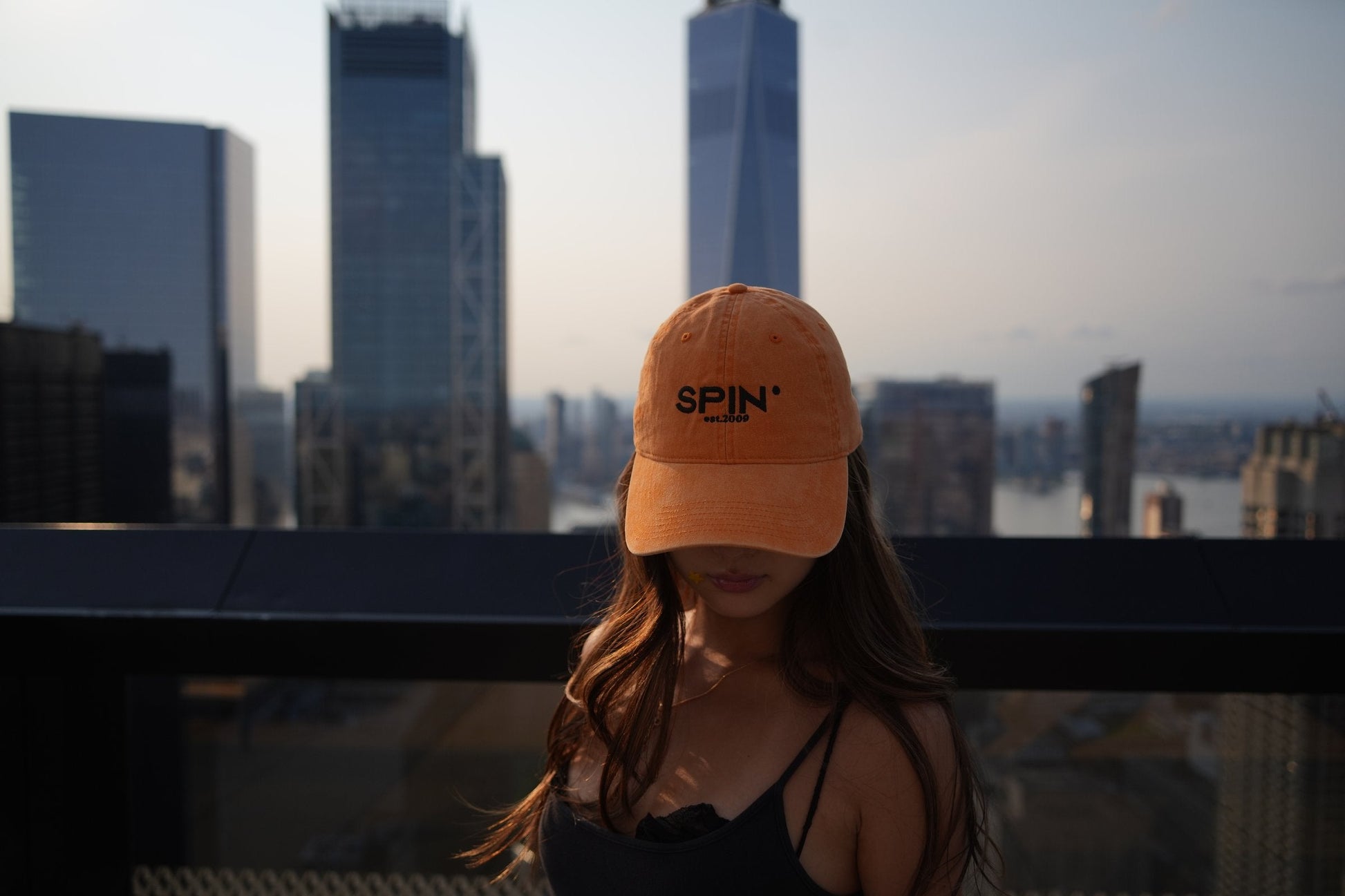 SPIN Club Cap orange below One World Trade