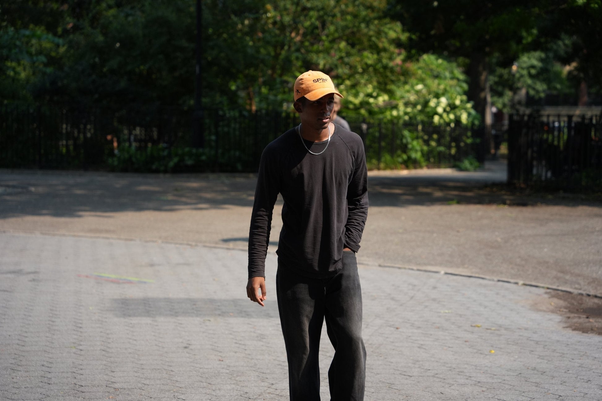 SPIN Club Cap orange, worn in the park